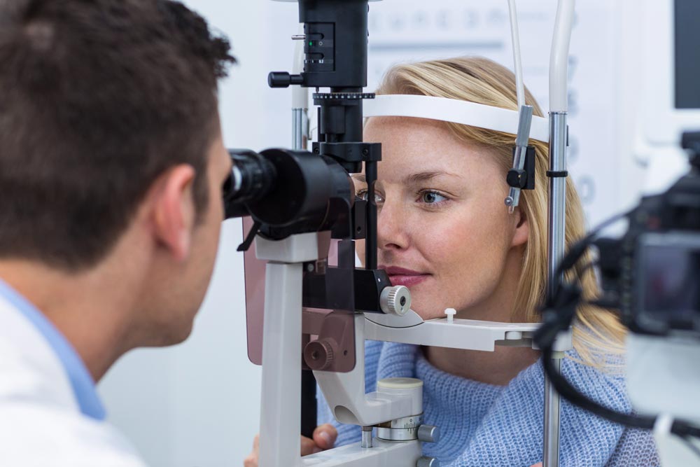 Woman at an eye exam with his eye doctor