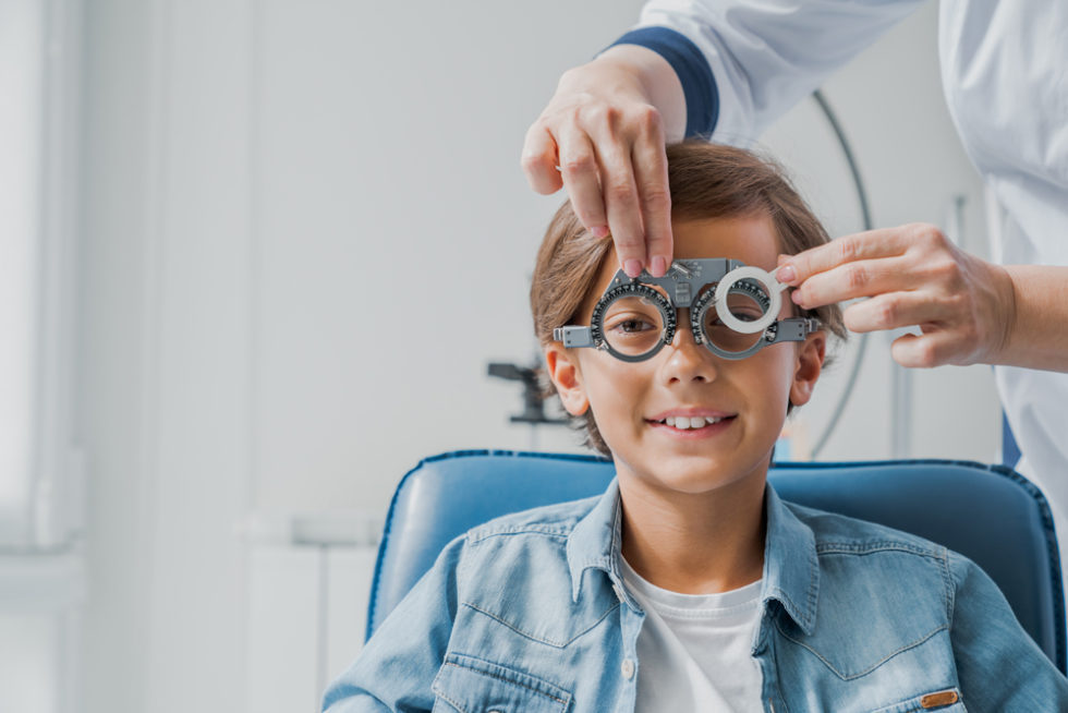 Boy having his eye examined by an eye doctor