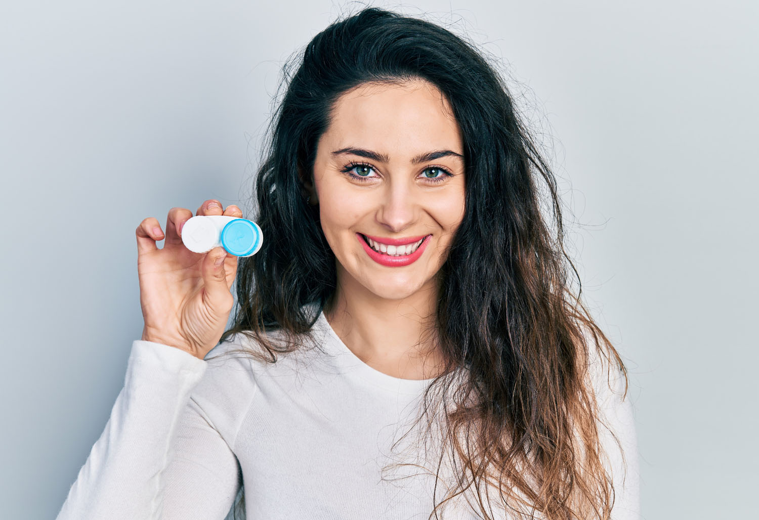 Woman holding her contact lens at Eyecare Specialties