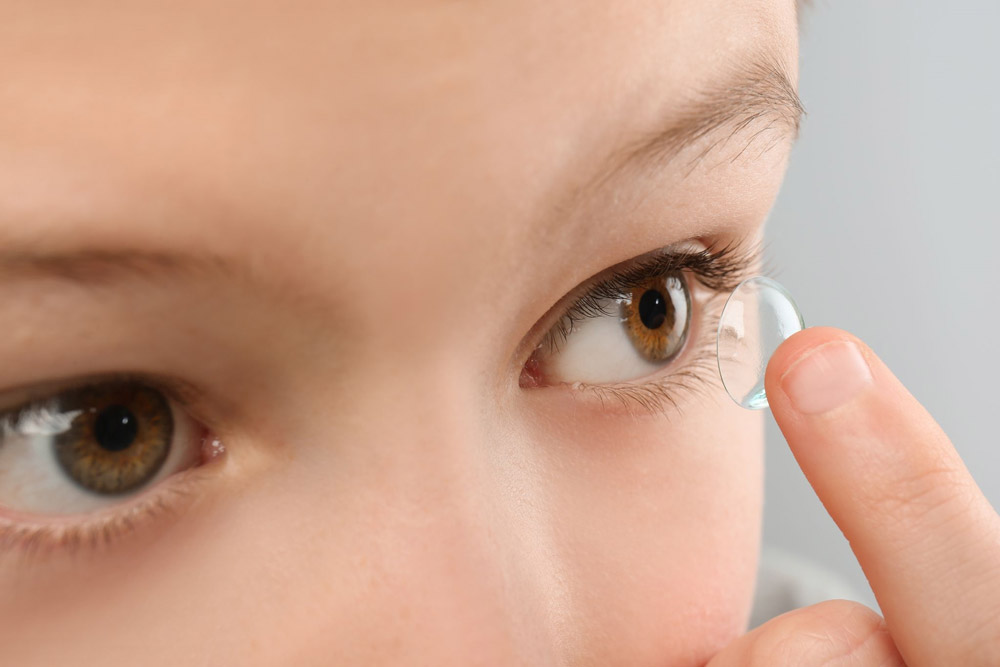 young eyecare specialties patient putting in a contact lens